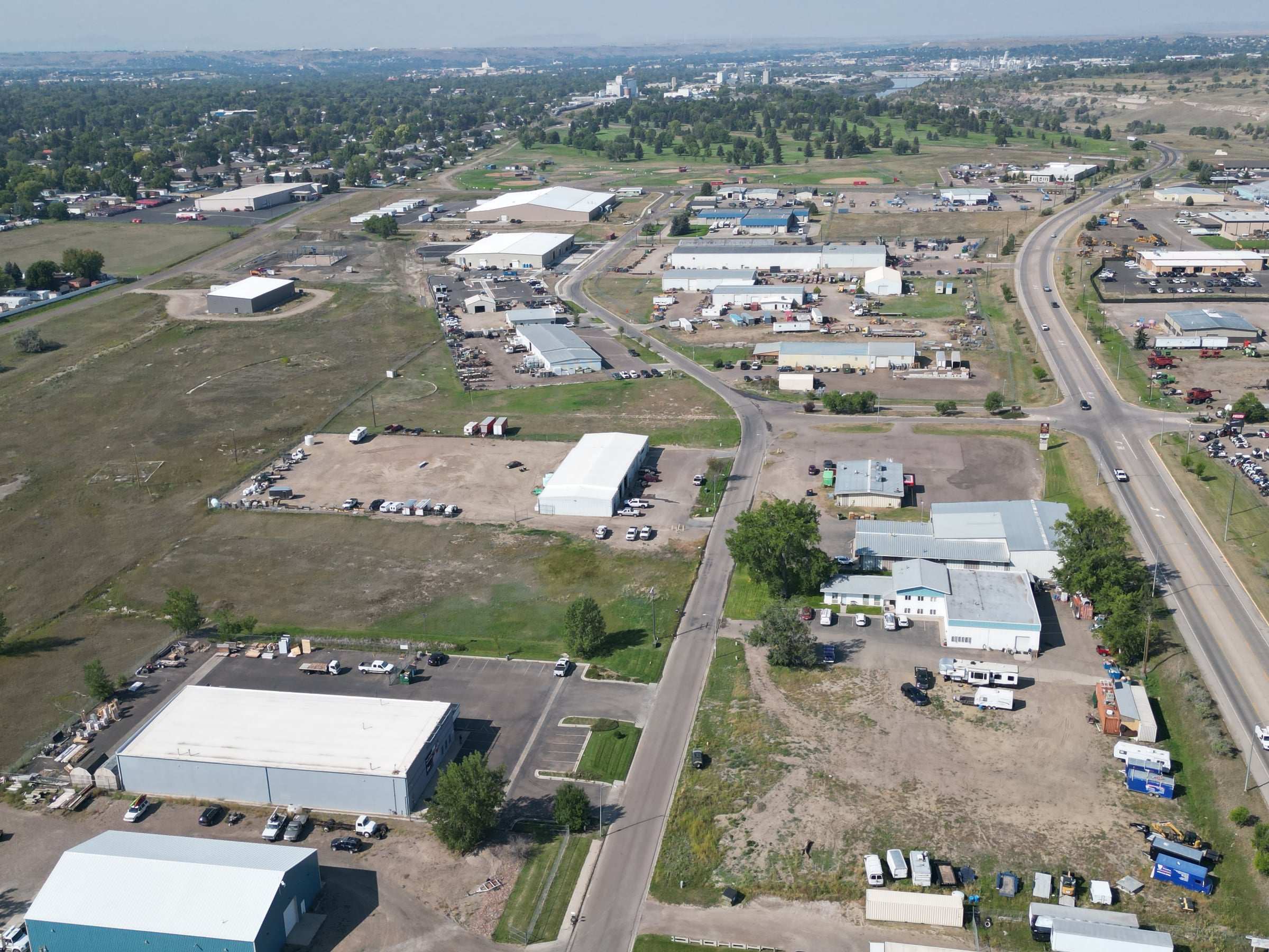 High aerial view over an industrial district toward downtown Great Falls, Montana